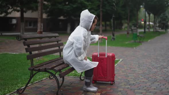Upset Little Woman Sighing Sitting on Bench in City Walking Away with Travel Bag alt