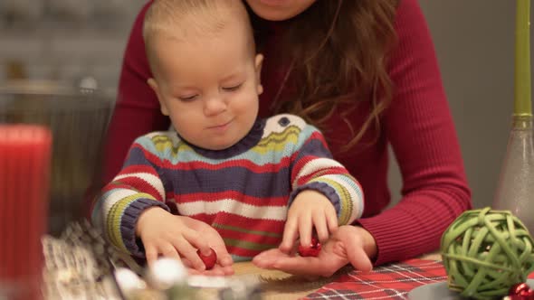 Cute Young Mother and a Baby Have Fun in Modern Kitchen alt