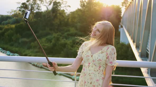 Woman Taking Selfie On Bridge Cheerful Pretty Blonde Young Lady Standing On Pedestrian Bridge 