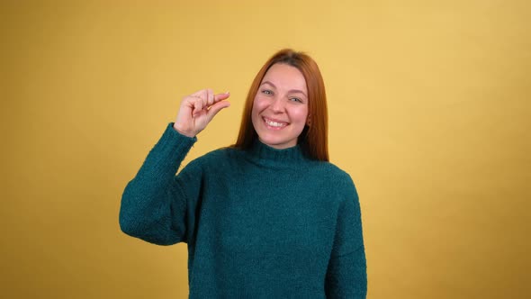 Young Red Hair Woman in Green Sweater Posing Isolated on Yellow Color Background Studio alt
