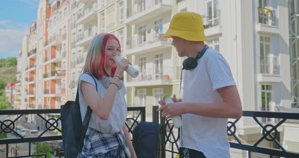 Urban Lifestyle of Teenagers, Couple of College Students Talking Having Rest Drinking Milk Drink in alt