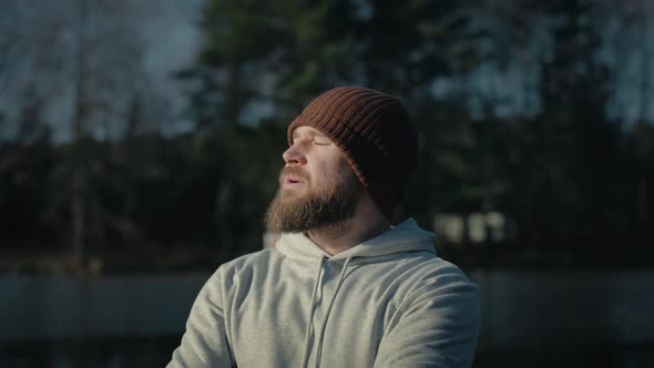 Caucasian man taking a breath in winter. Shot with RED helium camera in 8K. alt