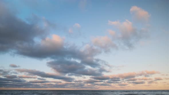 Blue Sky With Sunlit Clouds Over Horizon Of Sea alt