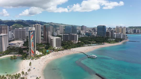 Aerial decreasing and panning shot of Waikiki on the island of O'ahu, Hawaii. 4K alt