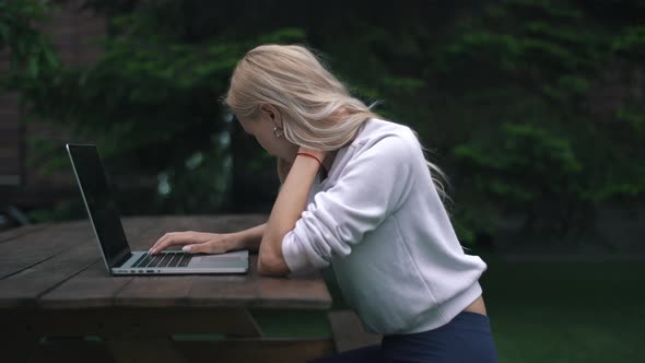 the Girl Felt a Pain in the Neck While Working on a Laptop