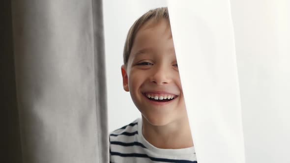 Emotions of the Child. Portrait of a Pre-school Boy Who Looks Into the Camera and Laughs. The Child alt