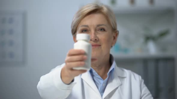 Female Doctor Showing Pills Bottle on Camera, Vitamins and Painkillers, Medicine