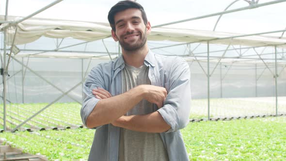 Young hispanic businessman farmer with looking at camera at quality standard organic farm.