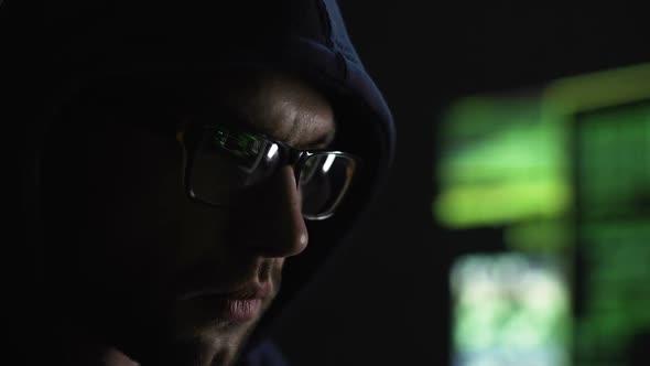 Strange Man Intently Gazing at Screen of Monitor, Engaged in Server Hacking alt