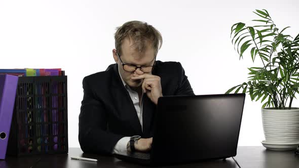 Tired Sleepy Businessman Working Hard in Office on Laptop Falling Asleep alt