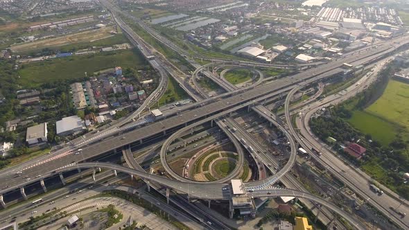 Aerial View of Highway Road Interchange with Busy Urban Traffic Speeding on Road alt