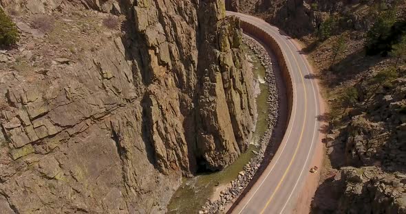 A drone shot descending to reveal a flyfisherman in the river deep within this majestic canyon. alt
