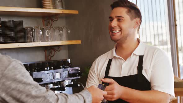Waiter and customer at counter alt