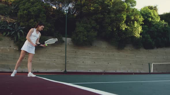 Woman playing tennis on a court alt