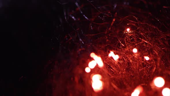 Macro of steel wool burning as fire moves through fibers. alt