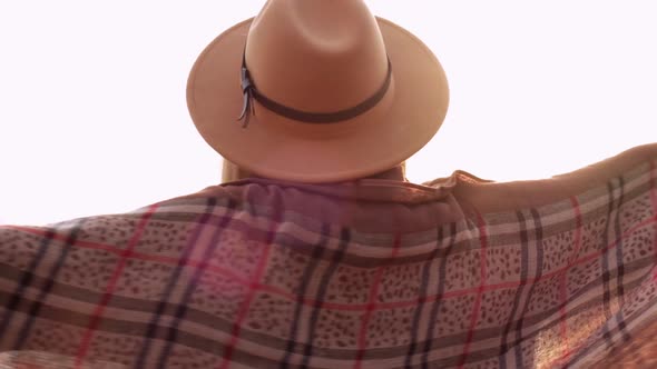 Slow Motion Caucasian Blonde Woman with Beige Hat Wearing Scarf Playing with Sunbeam in the alt