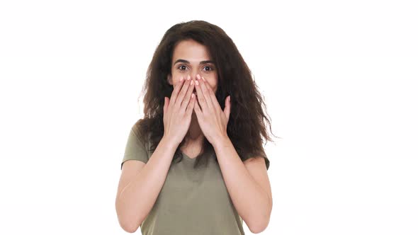Portrait of Young Woman 20s Expressing Surprise and Excitement Covering Open Mouth with Hands and alt