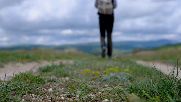 Tourist in Boots Going Along the Road on the Background a Beautiful Landscape alt