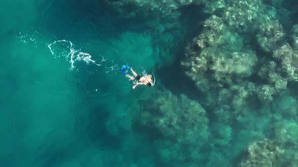 Beautiful Aerial Shot of Male Guy Snorkeling in Mask and Flippers at Coral Reef alt