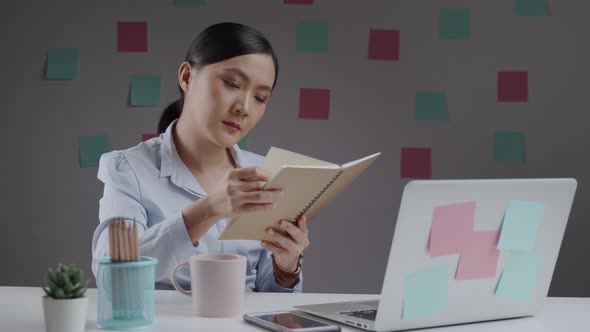 Asian woman happy relaxing and reading a book