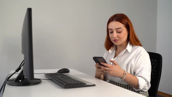 Woman Texting While Working on Computer in Office 4K alt