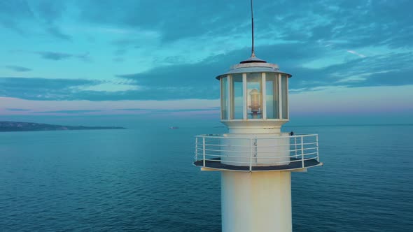 Drone Turns Around Lighthouse At Twilight During A Sunset 