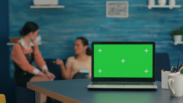 Two Women Sitting Together on Sofa in Background alt