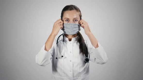 Doctor in medical mask puts off medical mask