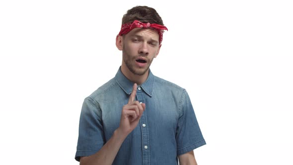 Sassy Handsome Bearded Guy with Red Headband Over Forehead Shaking Finger to Forbid Something