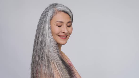 Happy Middle Aged Mature Asian Woman Portrait Smiling Looking at Camera alt