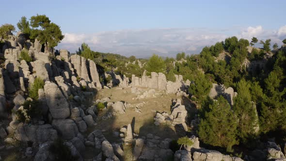 Stunning Aerial View of Rock Formations and Coniferous Forest at Mountains alt