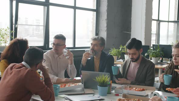 Happy Office Workers Eating Pizza During Work Break Talking Enjoying Food Together alt