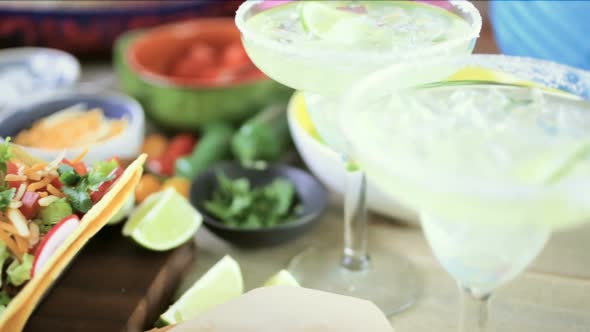 Ground beef tacos with romaine lettuce, diced tomatoes, radishes, and shredded cheddar cheese. alt