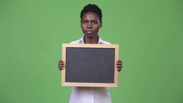 Young Beautiful African Businesswoman Holding Blackboard