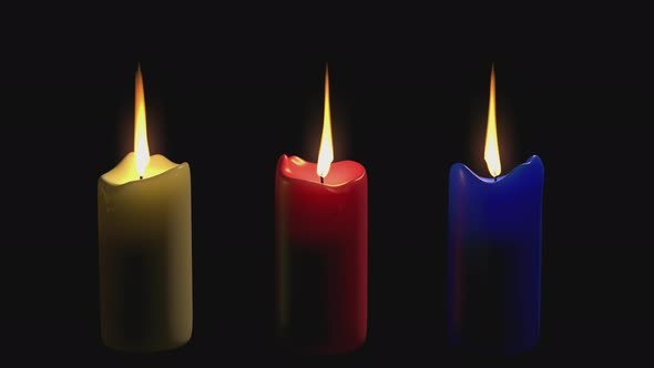 Three multi-colored candles are burning on a transparent background for chromakey.