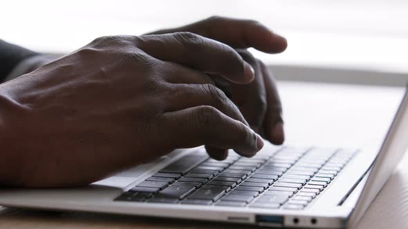Closeup Black Male Hands Typing on Laptop Keyboard at Office Table alt