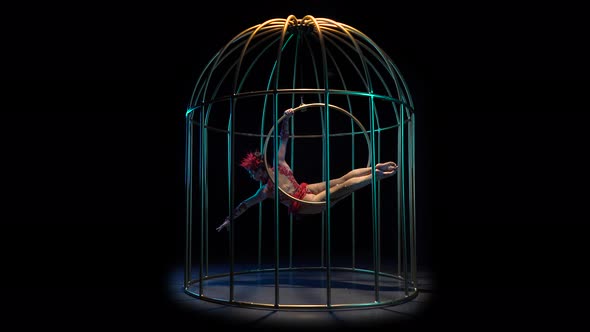 Girl Art Acrobatics on a Rotating Hoop in a Metal Cage, Black Background alt