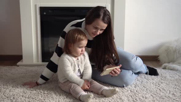 Cheerful Adorable Toddler Kid Daughter Enjoy Learning Using Smart Phone with Parental Control alt