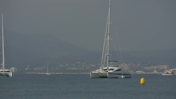 Catamaran yachts and other tourists boats alt