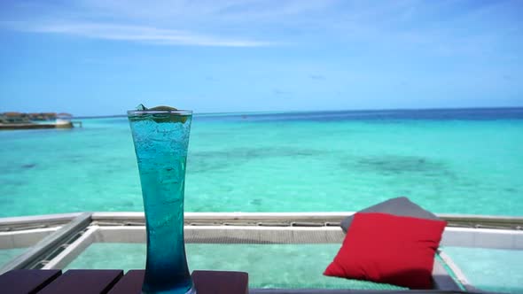 Blue Hawaii Cocktail And Maldives Sea Bar Red Pillow In Net Seat Over Ocean Luxury Lifestyle