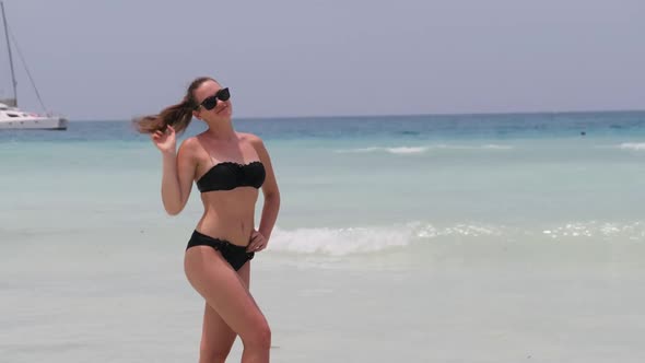 Young Woman in a Bikini Posing on Exotic Beach at the Turquoise Ocean Zanzibar alt
