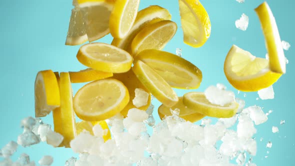 Super Slow Motion Shot of Flying Fresh Lemon Slices and Crushed Ice on Blue Background at 1000 Fps alt