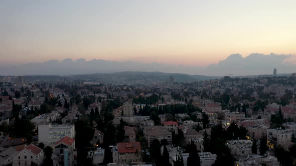 Aerial fly down shot over Jerusalem Nachlaot neighborhood at sunset, Israel alt