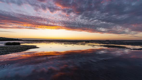 Isigny-Sur-Mer, France, Timelapse  - Reflection clip of the Baie des Veys during the Sunset