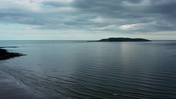 Aerial view over beach landscape and revealing the Irish sea alt