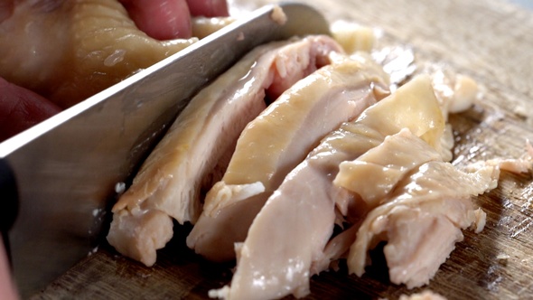 Chinese steamed hainanese chicken cutting by knife