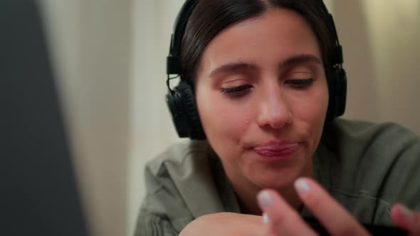 The Girl Fills in Information From a Bank Card on a Laptop