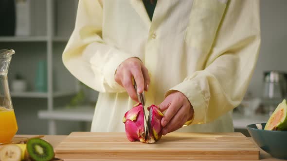 Woman Cutting Pitahaya Closeup Halves of Dragon Fruit Preparing Ingredients for Cooking Smoothie alt