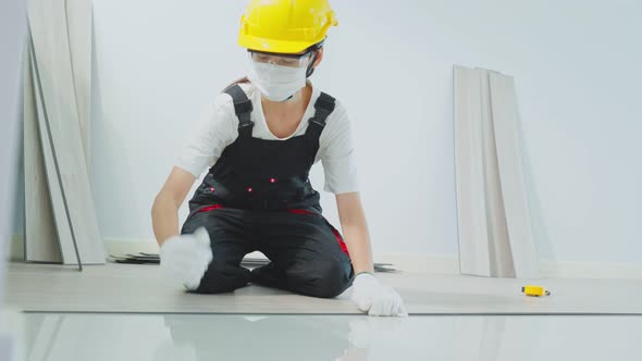 Asian Construction woman worker Joiner wear helmet and face mask work in site to renovate home. alt