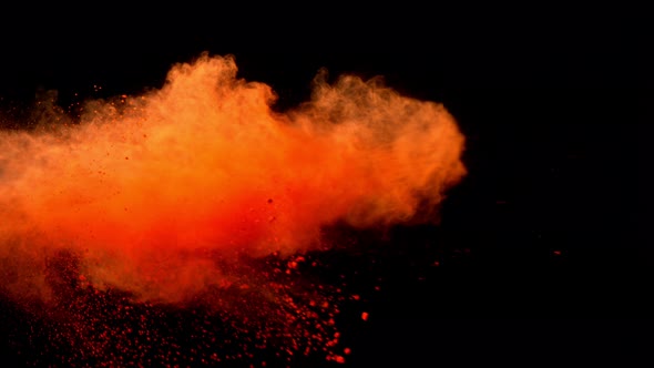 Super Slowmotion Shot of Orange Powder Explosion Isolated on Black Background alt